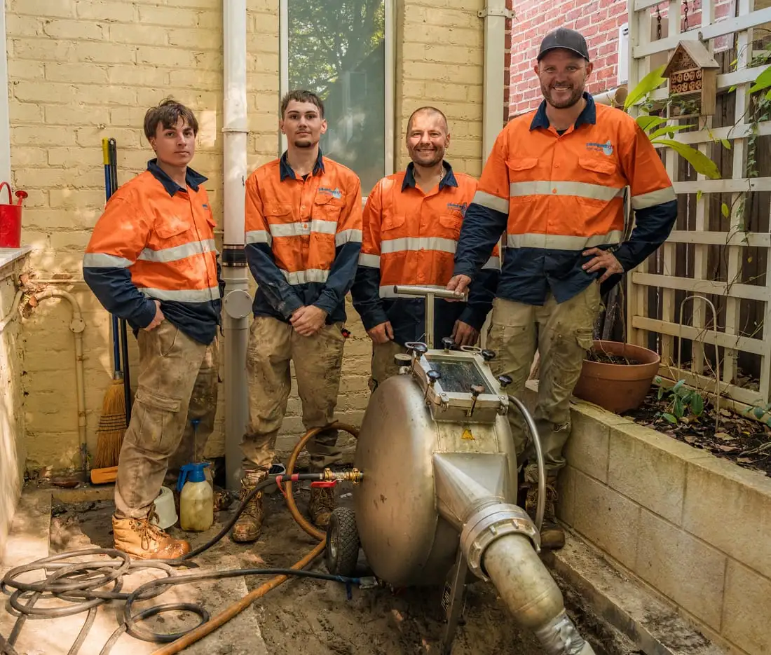 Four Pipe Relining Perth crew members beside their equipment.